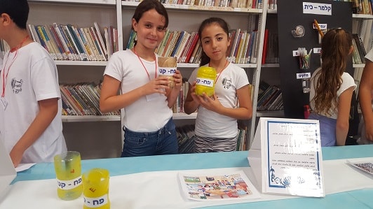 A small tin for each student attached to the table, an invention of Israeli girls