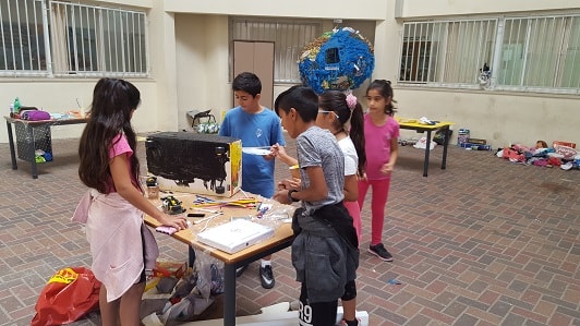 The children work in teams at Hackathon at the Ofek school