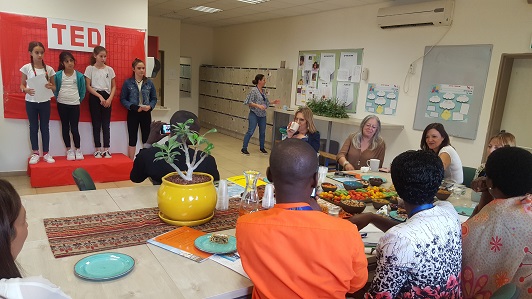 Students make a pitch to a delegation from Uganda